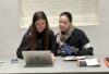 Women and girl using laptop together