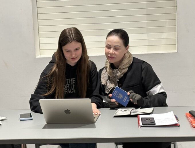 Women and girl using laptop together