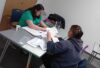 Two women looking at paperwork across a desk