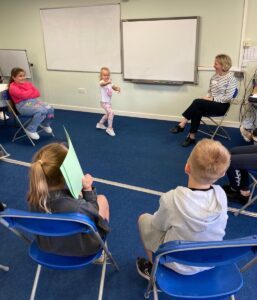 children in a group playing a game