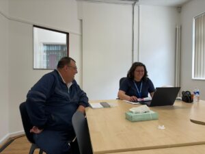 man and women sat at table with laptop