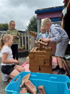 Children in a group playing with bricks