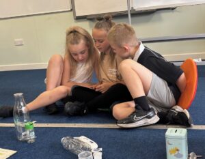 three children reading together
