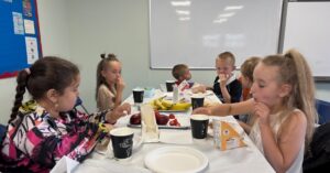Group of children at table eating